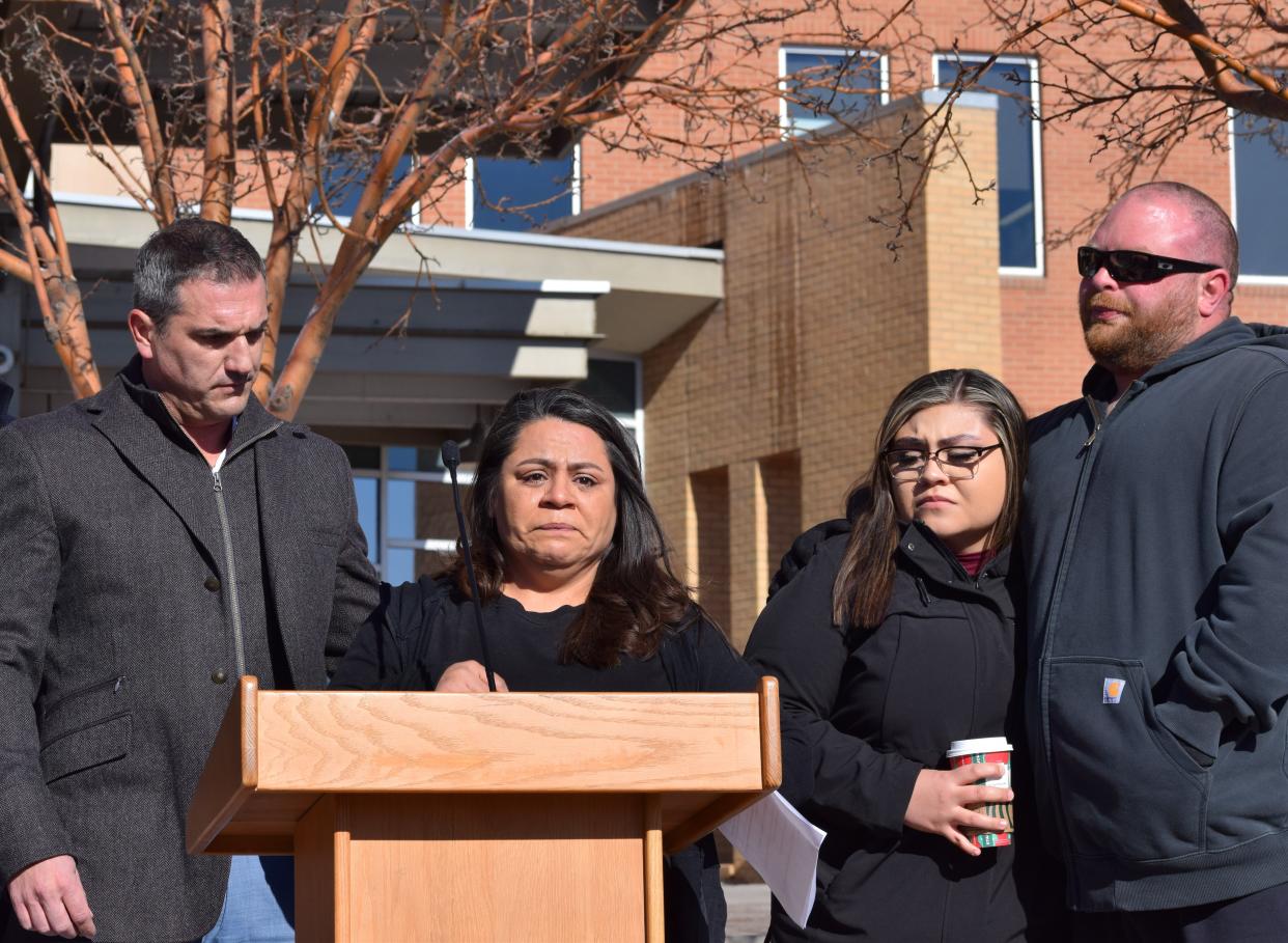 Dedra Jones, center, stands with attorney Jason Jordan, left, and members of the Jones family at a press conference announcing a wrongful death lawsuit against St. Mary Corwin Hospital and four security guards involved in a February 2021 altercation in which Jones' husband, Mathew Haskel Jones, was killed.