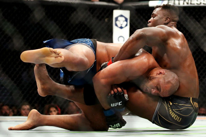 ANAHEIM, CALIFORNIA - JANUARY 22: Francis Ngannou of Cameroon (right) tackles Ciryl Gane of France in their heavyweight title fight during the UFC 270 event at Honda Center on January 22, 2022 in Anaheim, California. (Photo by Katelyn Mulcahy/Getty Images)