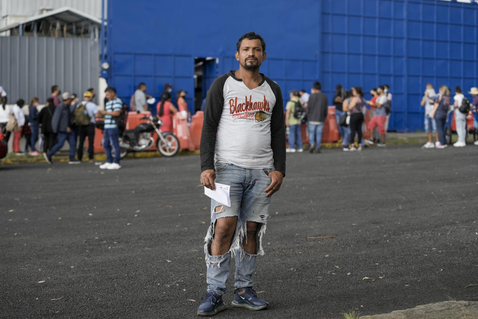 Nicaraguan David Esteban Narvaez poses for a portrait after receiving his asylum seeker credentials, which allows him to stay and work legally in Costa Rica, outside the Refugee Service Center in San Jose, Costa Rica, Monday, Aug. 29, 2022. Three months after applying for asylum, applicants can begin working legally, but many said that some employers do not recognize the government-issued card identifying them as asylum seekers. (AP Photo/Moises Castillo)