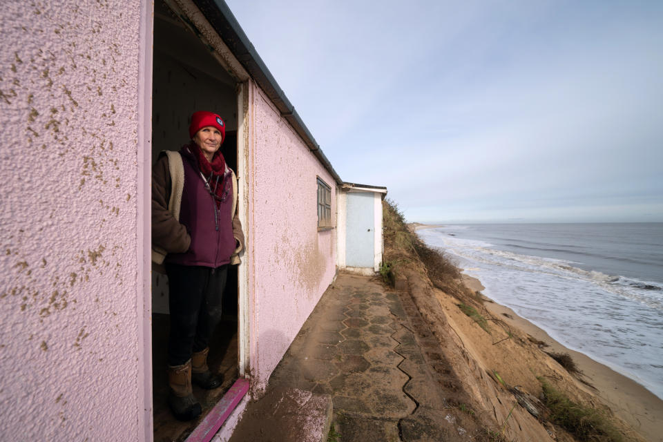 Hemsby resident Sue (surname not given) looks out from her home on the cliff edge at Hemsby. (Getty)