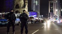 <p>Policemen stand guard at the scene where a truck crashed into a Christmas market in Berlin, Germany. Photo: Clemens Bilan/EPA via AAP</p>