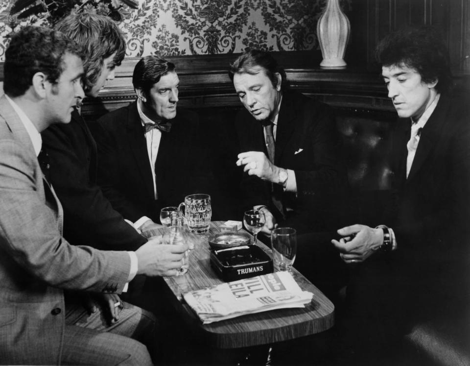 Tony Selby, left, with other henchmen planning a heist with Richard Burton, second right, in Villain (1971) - Metro-Goldwyn-Mayer/Getty Images