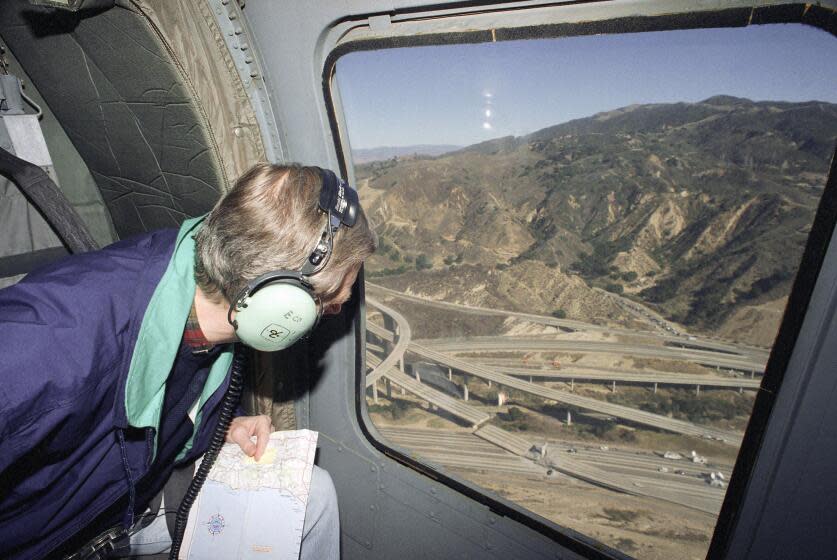 California Governor Pete Wilson views earthquake damage that caused the death of a California Highway Patrolman whose motorcycle ran off Interstate 14 while exiting to Interstate 5 when the highway separated in Los Angeles, Jan. 17, 1994. Nearly two dozen people have died in the earthquake. (AP Photo/Doug Pizac)