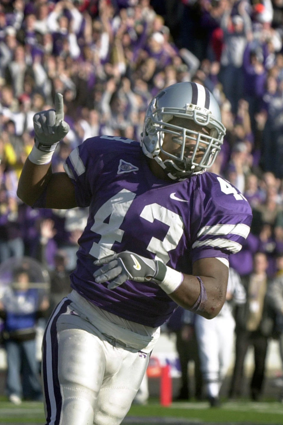 FILE - In this Nov. 16, 2002, file photo, Kansas State running back Darren Sproles celebrates after scoring a touchdown in the fourth quarter of an NCAA college football game, in Manhattan, Kan. Georgia cornerback Champ Bailey, Syracuse defensive end Dwight Freeney and Kansas State running back Darren Sproles will appear on the College Hall of Fame ballot for the first time. The National Football Foundation announced Tuesday, June 16, 2020, the 78 players and seven coaches from major college who are up for selection to the Hall of Fame. (AP Photo/Charlie Riedel, File)