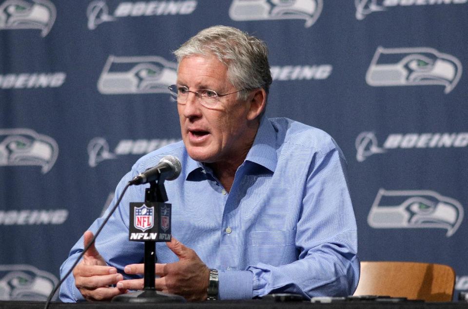 Seattle Seahawks NFL football head coach Pete Carroll talks to reporters Friday, April 4, 2014, in Renton, Wash. The Seahawks have locked up coach Carroll with a three-year contract extension after he led the franchise to its first Super Bowl title. (AP Photo/Marcus R. Donner)