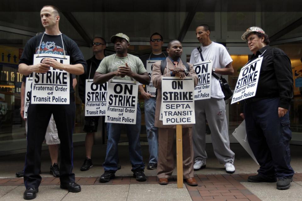 Striking Southeastern Pennsylvania Transportation Authority police officers picket outside the transit agency's offices Wednesday, March 21, 2012, in Philadelphia. (AP Photo/Matt Rourke)