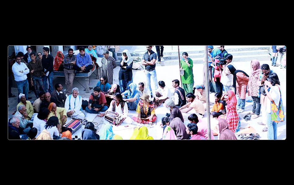 <b>THE INFORMAL SESSIONS/ GAVRA DEVI</b> If music and song were the heart of the yatra, the informal sessions between the yatris and individual singers were its soul. The explorations within this small satsang space lent it depth. Here Smriti’s lens captures a dramatic moment of focus around Gavra Devi, the local folk star. Gavra Devi shared her life-story, sang, explained the poetry, and regaled everybody with her devilish humour. Blind almost since birth, she lit up the gathering with the humility, honesty, humour and sheer warmth of her being. Of the bhajans, she said, “maine hriday mein dhar liye” (I established them in my heart).