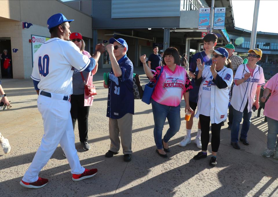 New York Boulders pitcher Algenis Martinez greets fans before Thursday's home opener at Clover Stadium in Pomona.