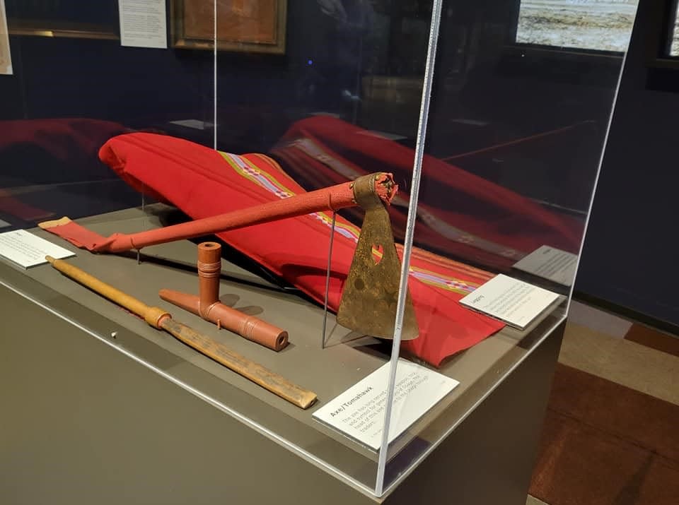 An Osage pipe, tomahawk and unfinished broadcloth legging are displayed on Oct. 12 in the pocket exhibit "Trust and Betrayal in Osage Country" at the Oklahoma History Center.