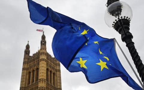 The EU flag flies outside parliament in London - Credit: EPA/ANDY RAIN