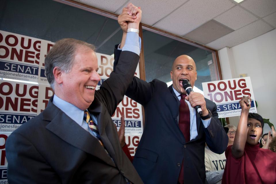 Sen. Cory Booker raises the arm of Doug Jones while speaking at Jones’s campaign headquarters in Birmingham, Ala., on Dec. 10. (Photo: Jim Watson/AFP/Getty Images)