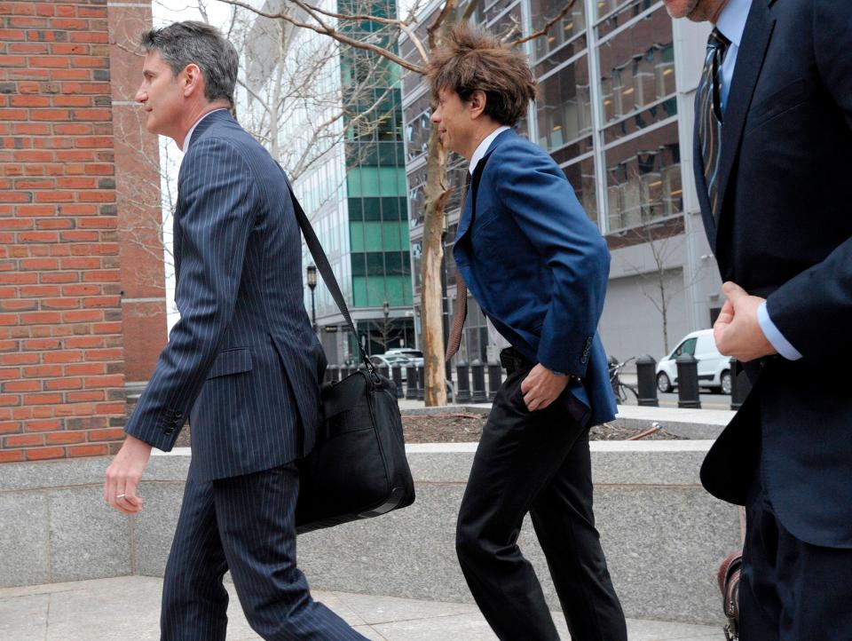 Napa Valley Vintner, Agustin Huneeus Jr., (C) makes his way to the John Joseph Moakley United States Courthouse to plea in front of a judge for charges in the college admissions scandal, on March 29, 2019, in Boston. (Photo by Joseph Prezioso / AFP)JOSEPH PREZIOSO/AFP/Getty Images ORG XMIT: Wealthy U ORIG FILE ID: AFP_1F81YH
