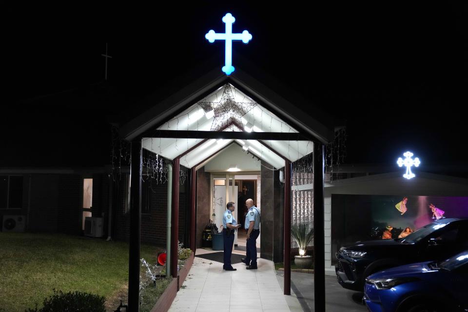 Security officers stand guard outside Orthodox Assyrian church in Sydney, Australia, Monday, April 15, 2024. Police in Australia say a man has been arrested after a bishop and churchgoers were stabbed in the church. There are no life-threatening injuries. (AP Photo/Mark Baker)