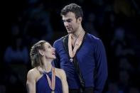 Gold medalists Meagan Duhamel and Eric Radford of Canada wait on the medal stand. REUTERS/Brian Snyder