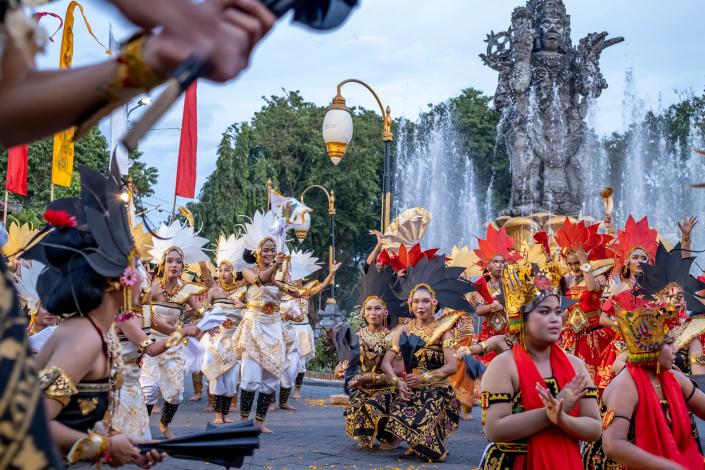 Balinese dancers perform as they take part in a cultural parade, during a new year's eve celebration at a main road in Denpasar (EPA)