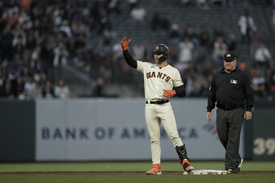 San Francisco Giants' Patrick Bailey, left, reacts after hitting an RBI double against the Cincinnati Reds during the third inning of a baseball game Monday, Aug. 28, 2023, in San Francisco. (AP Photo/Godofredo A. Vásquez)