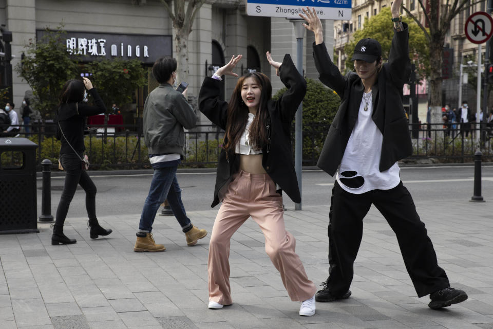 Chinese youths record a dance routine on the streets of Wuhan (Ng Han Guan/AP)