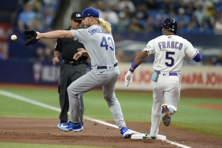 Tampa Bay Rays'  Wander Franco (5) beats the throw to Los Angeles Dodgers starting pitcher Noah Syndergaard.