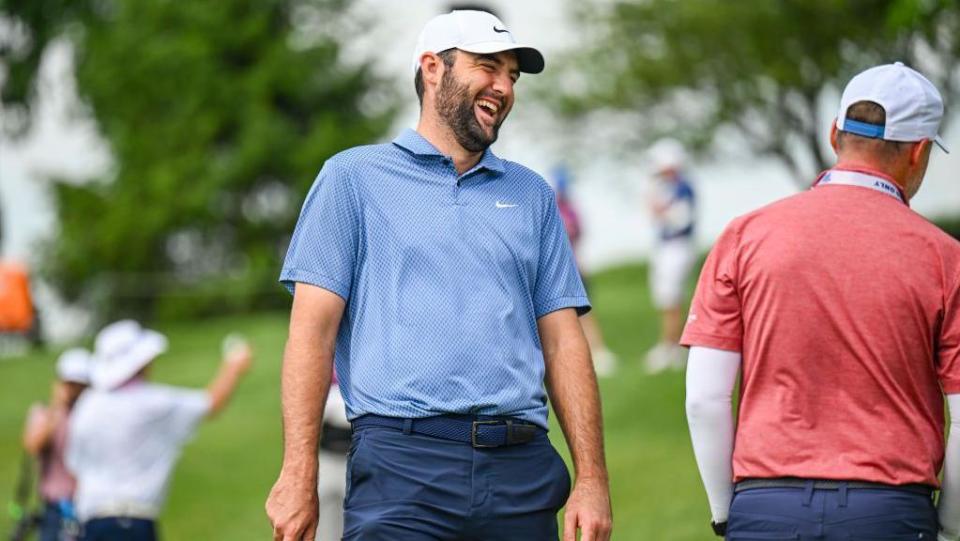 Scottie Scheffler laughs on the practice range at Valhalla Golf Club