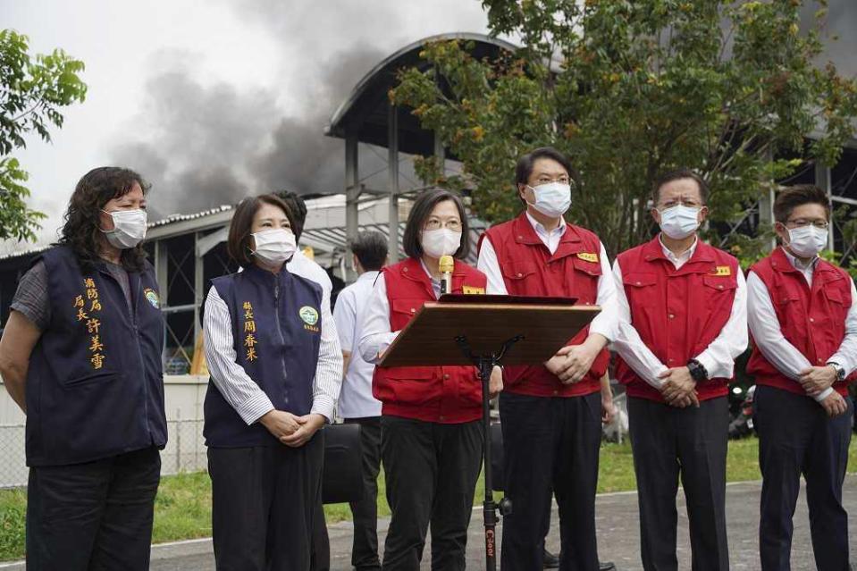 CORRECTS THE DATE TO SATURDAY, NOT FRIDAY - In this image provided by the Pingtung County Government, Taiwan's President Tsai Ing-wen, center, speaks near the scene of a factory fire at golf ball manufacturer Launch Technologies Co. in the southern county of Pingtung in Taiwan on Saturday, Sept. 23, 2023. The factory fire has left multiple people killed, and the victims include several firefighters, according to Taiwanese media reports. (Pingtung County Government via AP)
