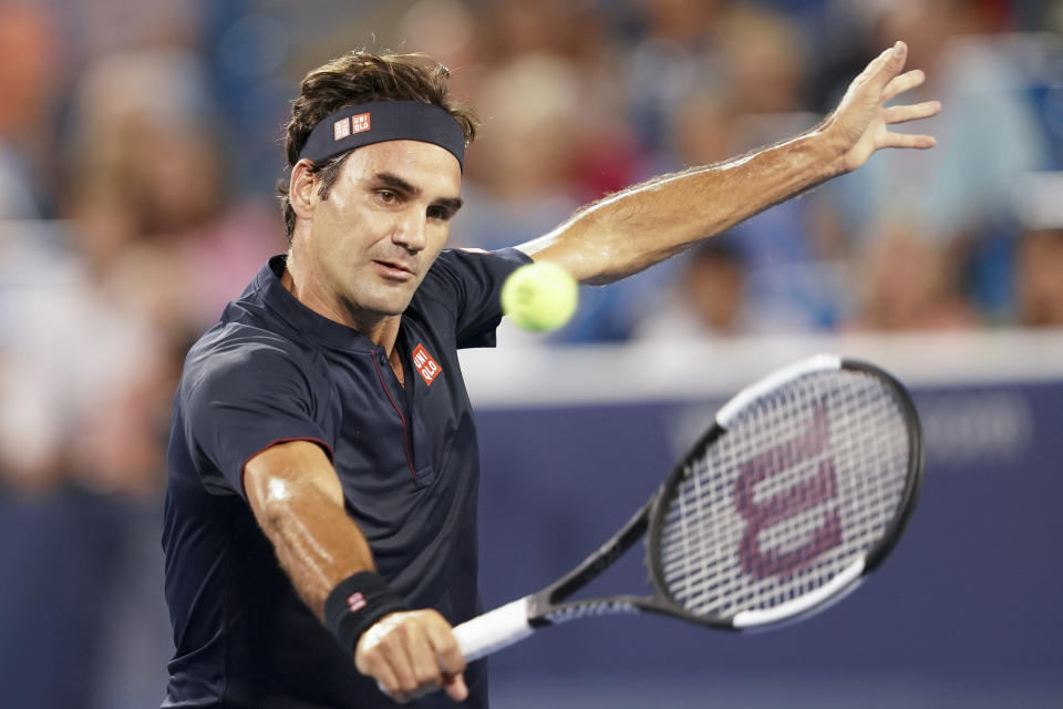 Roger Federer, of Switzerland, returns to Stan Wawrinka, of Switzerland, during the quarterfinals of the Western & Southern Open tennis tournament Friday, Aug. 17, 2018, in Mason, Ohio. (AP Photo/John Minchillo)