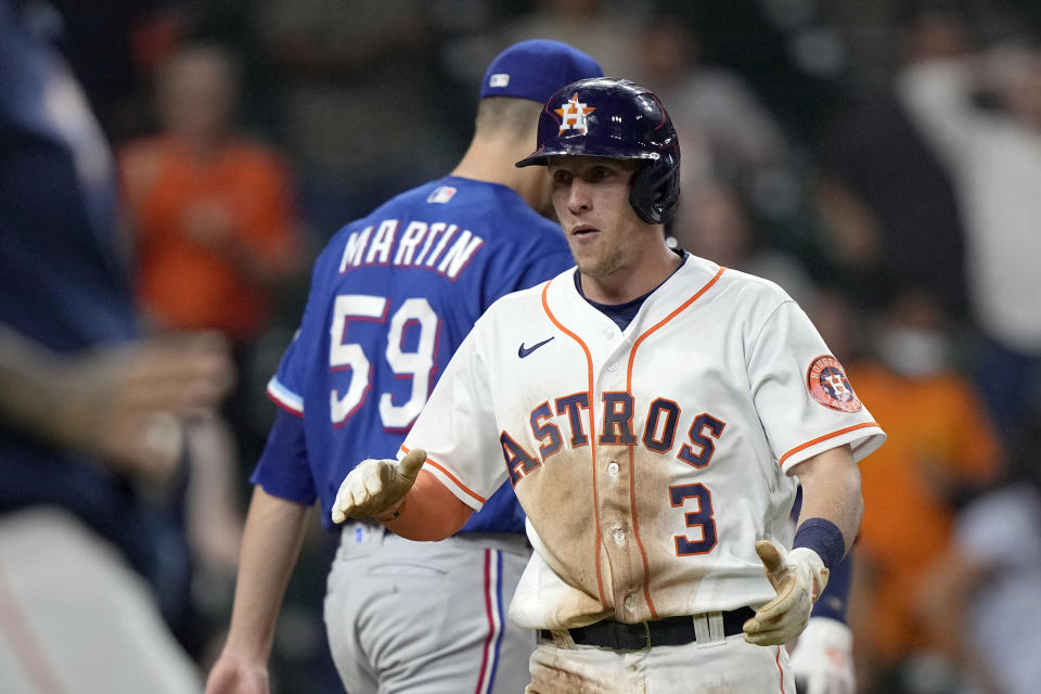 Houston Astros' Myles Straw (3) celebrates after scoring the game-winning run on a wild pitch by Texas Rangers relief pitcher Brett Martin (59) during the 11th inning of a baseball game Thursday, May 13, 2021, in Houston. The Astros won 4-3 in 11 innings. (AP Photo/David J. Phillip)