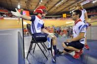 Britain's Jody Cundy (L) talks with para-cycling coach Chris Furber (R) after being denied a restart in the men's individual C4-5 1km time trial cycling event during the London 2012 Paralympic Games at the Olympic Park's Veldrome in east London on August 31, 2012