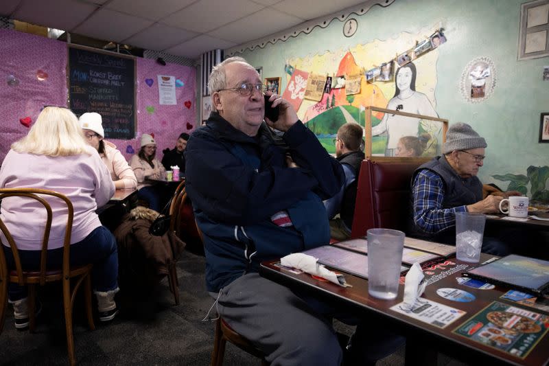 Dave Brummel speaks on the phone as he has breakfast in a cafe, in Des Moines