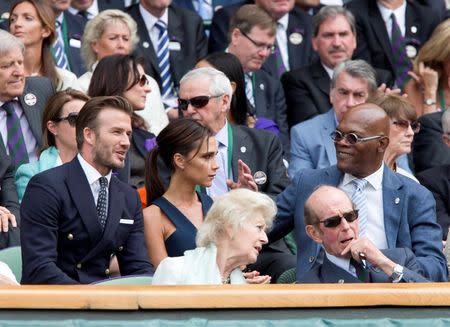 Jul 6, 2014; London, United Kingdom; Former soccer player David Beckham and wife Victoria Beckham talk with movie actor Samuel L. Jackson during the match between Novak Djokovic (SRB) and Roger Federer (SUI) on day 13 of the 2014 Wimbledon Championships at the All England Lawn and Tennis Club. Susan Mullane-USA TODAY Sports