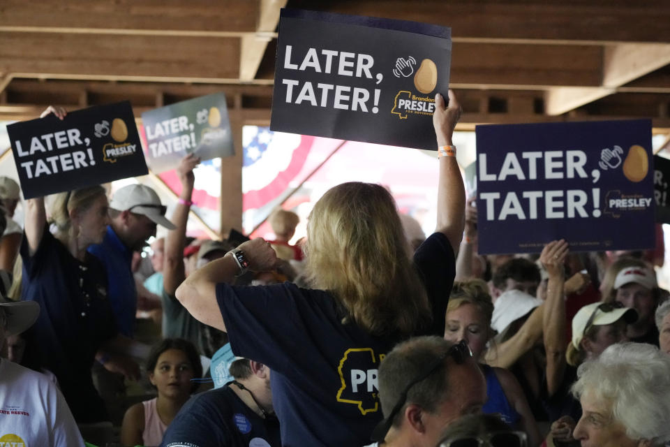 Democrat Brandon Presley's supporters wave signs during his speech at the Neshoba County Fair in Philadelphia, Miss., Thursday, July 27, 2023. Presley is running for governor in the November general election. (AP Photo/Rogelio V. Solis)