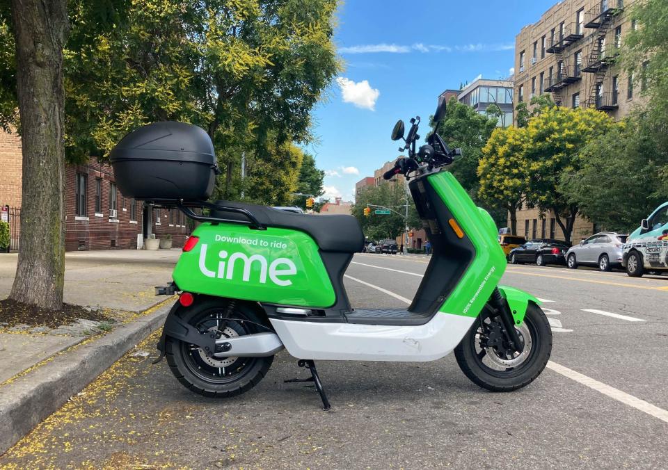 A bright green electric moped from the micromobility company Lime.