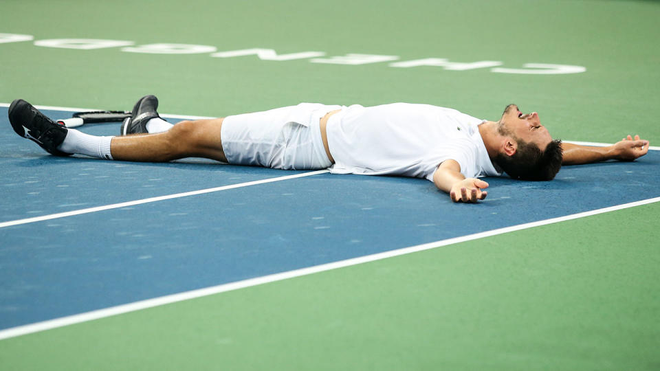 Bernard Tomic celebrates victory. (Photo by Zhizhao Wu/Getty Images)