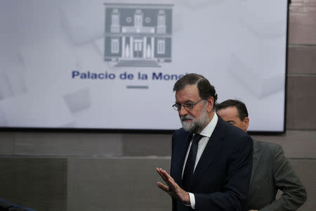 Spain's Prime Minister Mariano Rajoy leaves the stage after making a statement at the Moncloa Palace in Madrid, Spain, September 20, 2017. REUTERS/Sergio Perez