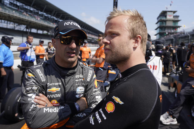 Tony Kanaan, left, of Brazil, talks with Felix Rosenqvist, of Sweden, during qualifications for the Indianapolis 500 auto race at Indianapolis Motor Speedway, Saturday, May 20, 2023, in Indianapolis. (AP Photo/Darron Cummings)