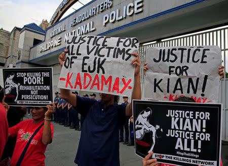 Protesters hold placards seeking justice for 17-year-old high school student Kian delos Santos, who was killed in a recent police raid in an escalation of President Rodrigo Duterte's war on drugs, during a protest in front of the Philippine National Police (PNP) headquarters in Quezon city, Metro Manila, Philippines August 23, 2017. REUTERS/Romeo Ranoco