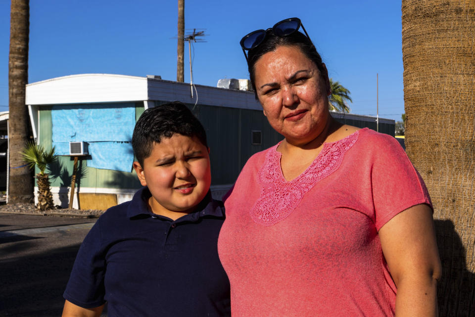 Mobile home residents Graciela Beltran and her son on Tuesday, April 11, 2023, in Phoenix Ariz. Dozens of families face eviction from there mobile homes to make room for student housing. (AP Photo/Ty O'Neil)