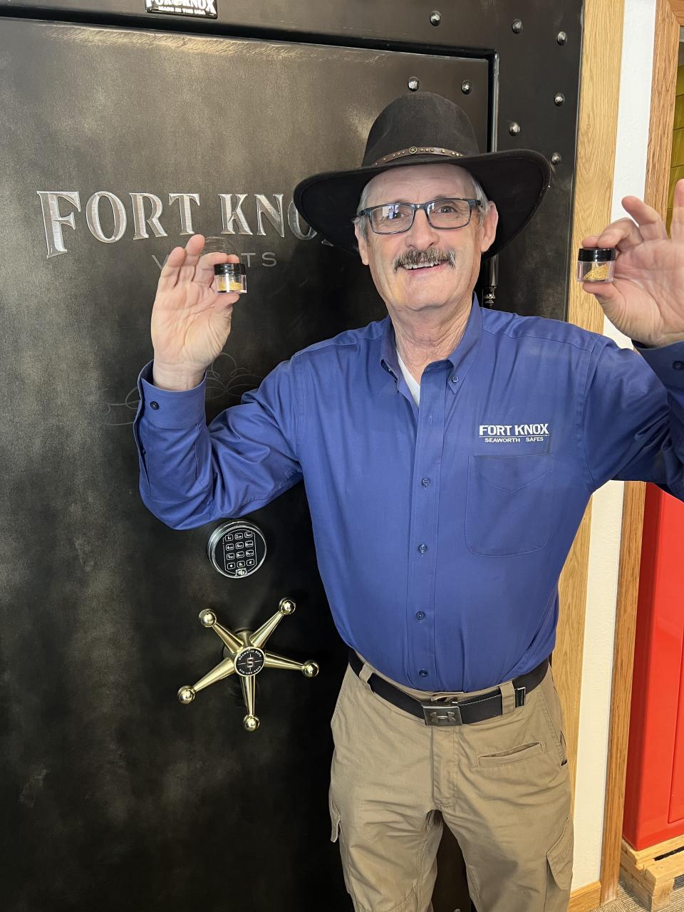 Bill Seaworth of Fort Collins holds up two jars each containing a half ounce of gold mined from the Poudre River he will auction off at the Poudre High School Future Farmers of America fundraiser Friday.
