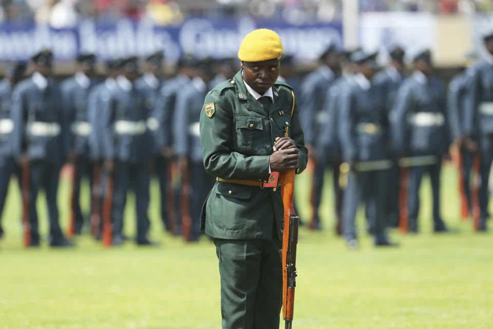 A soldier stands guard as the remains of the late former Zimbabwean leader, Robert Mugabe arrive at the National Sports stadium during a funeral procession in Harare, Saturday, Sept, 14, 2019. African heads of state and envoys are gathering to attend a state funeral for Mugabe, whose burial has been delayed for at least a month until a special mausoleum can be built for his remains. (AP Photo/Tsvangirayi Mukwazhi)