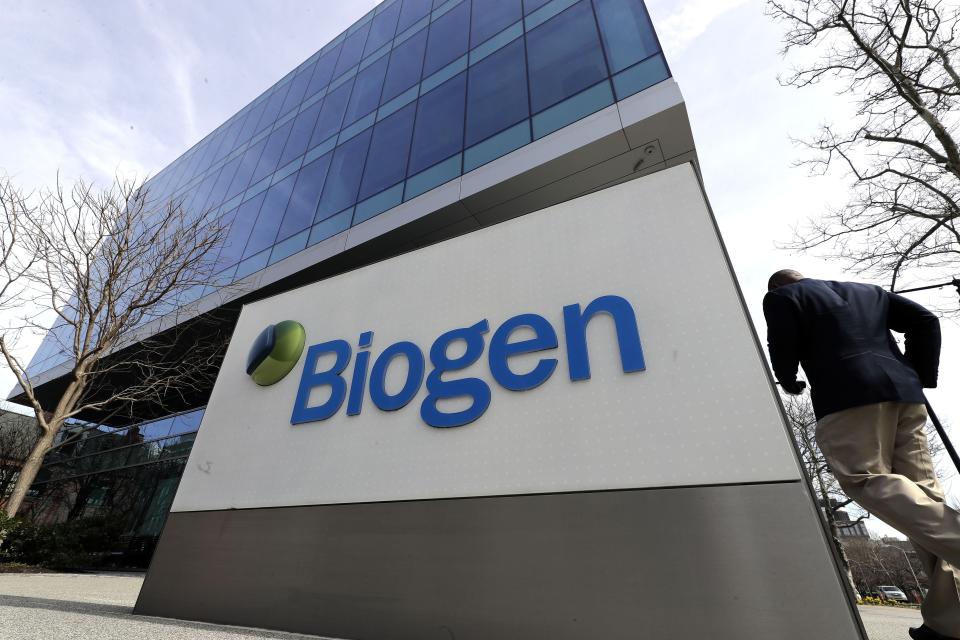 A man walks outside the Biogen Inc., headquarters, Wednesday, March 11, 2020, in Cambridge, Mass. Seventy of Massachusetts' first 92 confirmed coronavirus cases have been linked to a meeting of Biogen executives that was held at the Marriott Long Wharf hotel in Boston in late February 2020. For most people, the virus causes only mild or moderate symptoms, such as fever and cough. For some, especially older adults and people with existing health problems, it can cause more severe illness, including pneumonia. The vast majority of people recover from the new virus. (AP Photo/Steven Senne)