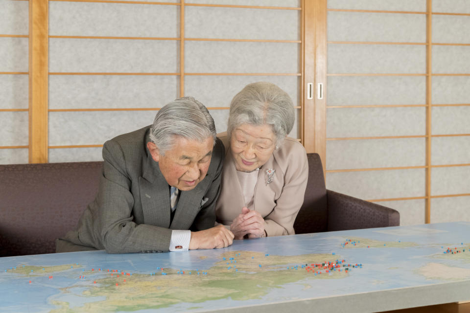 In this Monday, Dec. 10, 2018, photo released on Friday, Dec. 21, 2018, by the Imperial Household Agency of Japan, Japan's Emperor Akihito, left, and Empress Michiko, right, look at a map at the Imperial residence of the Imperial Palace in Tokyo. Emperor Akihito, who turns 85 on Sunday, Dec. 23, and will abdicate this spring, says he feels relieved to see the era of his reign coming to an end without having seen his country at war. (The Imperial Household Agency of Japan via AP)