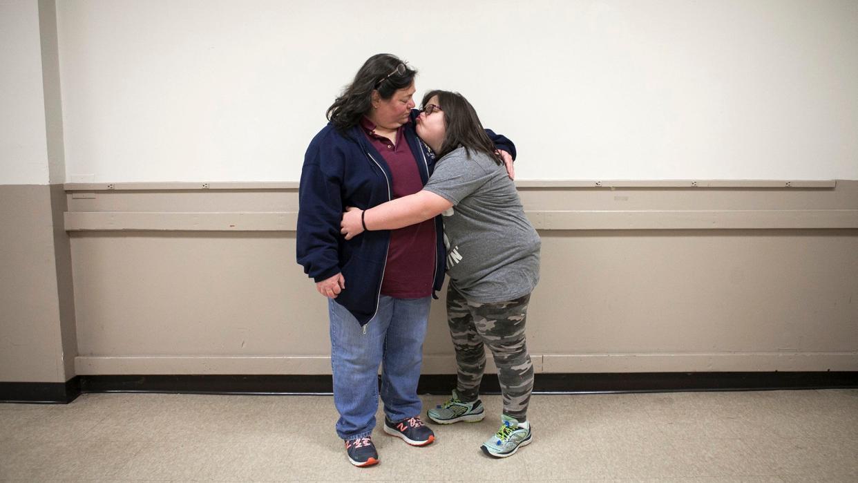 Marjorie Guldan and her daughter Rebecca, 14, hug after the Deer Park 4-H Club holiday party. (Photo: Laura Elizabeth Pohl for HuffPost)