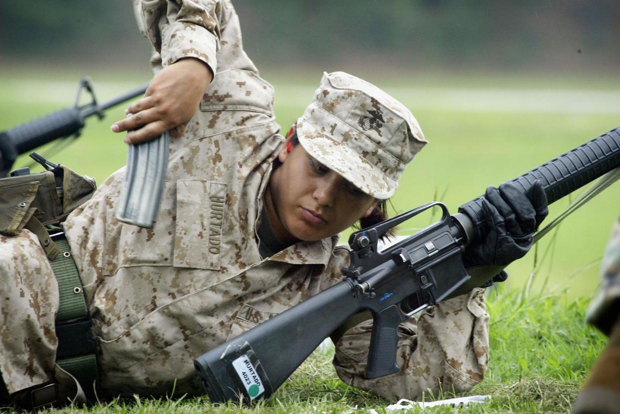 A Female Marine Corps recruit loads her rifle while training on the rifle range at the United States Marine Corps recruit depot June 21, 2004 in Parris Island, South Carolina: Scott Olson/Getty Images