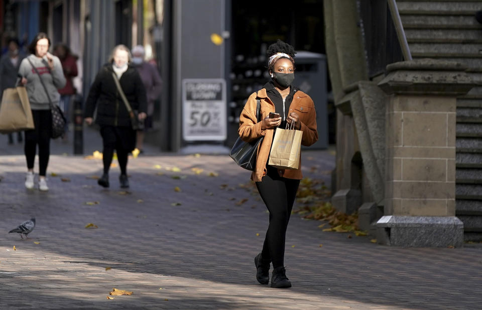 A shopper wears a face mask in Nottingham, where Tier 3 coronavirus restrictions will come into force at midnight.