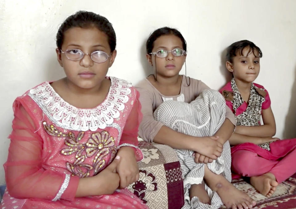 This July 11, 2018, photo, shows the daughters of Khaled Elwiya, who is one of seven men killed after a drone struck the vehicle with two US-made missiles, killing all seven men inside, instantly ending their lives, shredding their bodies into pieces, at their home in Shabwa, Yemen. (AP Photo)