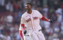 Boston Red Sox's Franchy Cordero celebrates after hitting a grand slam in the tenth inning of a baseball game against the Seattle Mariners, Sunday, May 22, 2022, in Boston. The Red Sox won 8-4. (AP Photo/Steven Senne)