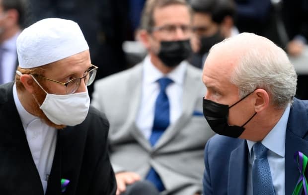 Conservative Leader Erin O'Toole, right, speaks with London Muslim Mosque imam Abd Alfatah Twakkal at a vigil for the victims of the deadly vehicle attack on five members of the Canadian Muslim community in London, Ont., on Tuesday, June 8, 2021. The party has little diverse representation in its Commons caucus after Monday's vote. (Nathan Denette/Canadian Press - image credit)