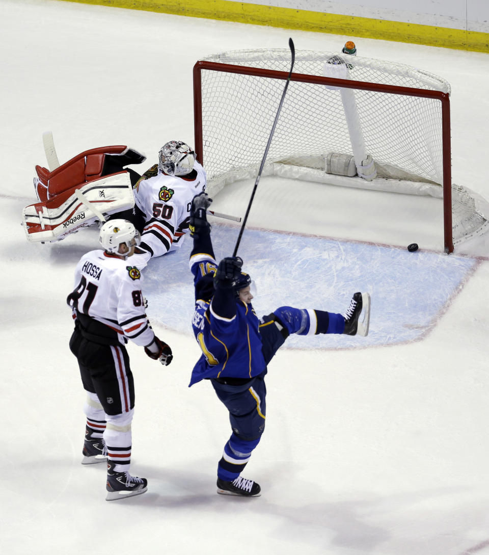 St. Louis Blues' Vladimir Tarasenko, of Russia, celebrates after scoring past Chicago Blackhawks goalie Corey Crawford (50) and Marian Hossa (81), of Slovakia, during the first period in Game 1 of a first-round NHL hockey Stanley Cup playoff series Thursday, April 17, 2014, in St. Louis. (AP Photo/Jeff Roberson)