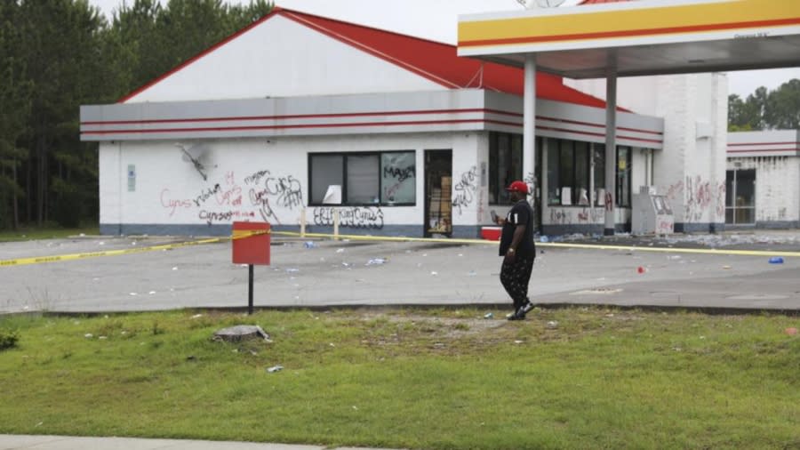 A man walks in front of police tape placed in front of the Xpress Mart convenience store Tuesday in Columbia, South Carolina where Richland County deputies said owner Rick Chow chased a 14-year-old he thought shoplifted, but didn’t steal anything. He fatally shot Cyrus Carmack-Belton in the back. (Photo: Jeffrey Collins/AP)