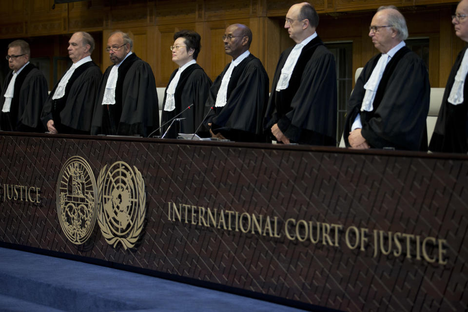 Judges enter the International Court of Justice, or World Court, in The Hague, Netherlands, Wednesday, Oct. 3, 2018, where they ruled on an Iranian request to order Washington to suspend U.S. sanctions against Tehran. (AP Photo/Peter Dejong)