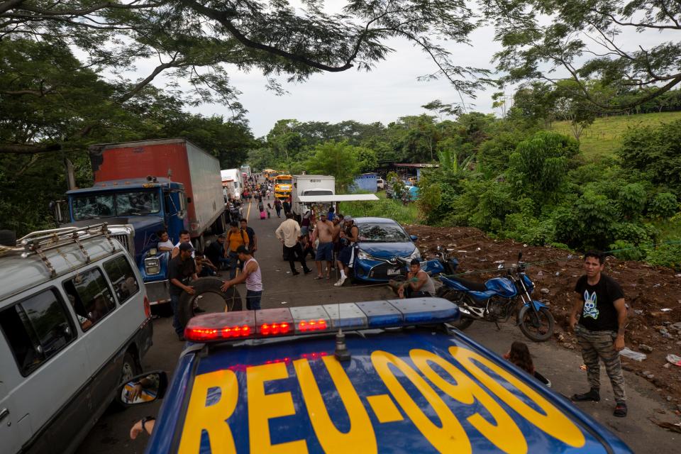 Protestors allow a police vehicle to cross north on Highway 2 at a blockade on Oct. 8, 2023. Emergency vehicles were also given permission to cross the blockades by the protestors.